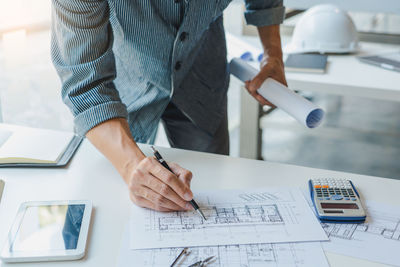 Low angle view of man working on table