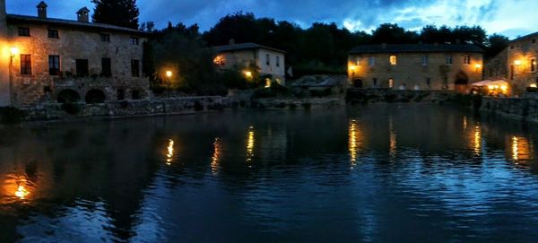 Reflection of illuminated buildings in water at night