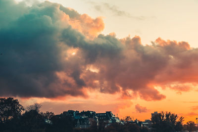 Silhouette buildings against sky during sunset