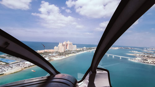 Panoramic view of sea and cityscape against sky