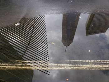 Reflection of building in puddle