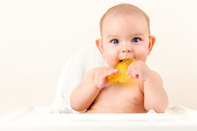 Portrait of cute boy eating baby