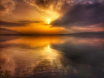 Scenic view of sea against romantic sky at sunset