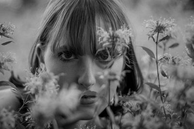 Close-up of beautiful woman looking through plants