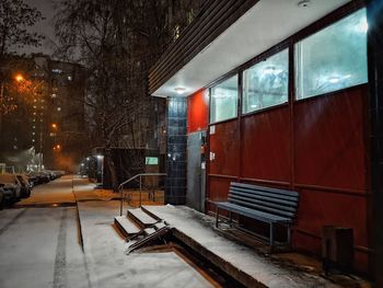 View of wet street in city during winter