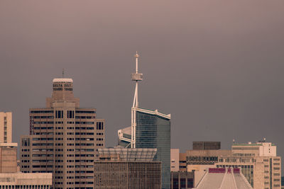 Modern buildings in city against clear sky