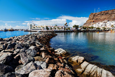 Groynes in sea with residential district in background