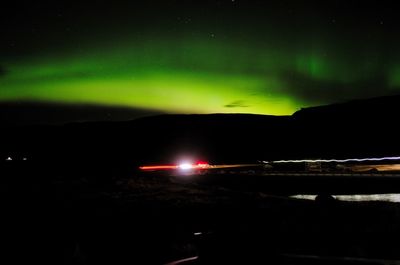 Illuminated lights against sky at night