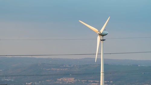 Low angle view of wind turbine against sky