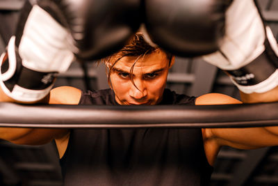 Man looking down in boxing ring