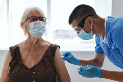 Doctor injecting vaccine to patient