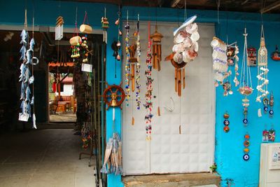 Multi colored decorations hanging on wall of building