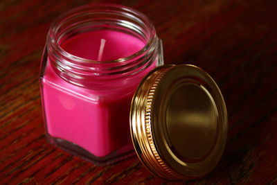 High angle view of a candle in jar on table