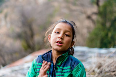 Portrait of woman standing outdoors