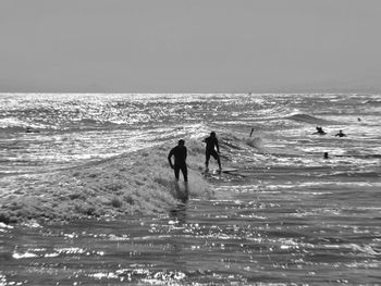 People on beach against sky