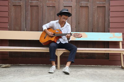 Full length of man playing guitar