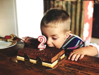 Portrait of boy with ice cream on table