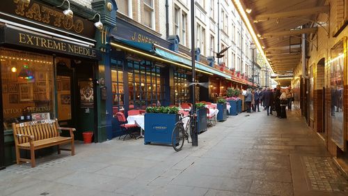 People at sidewalk cafe in city