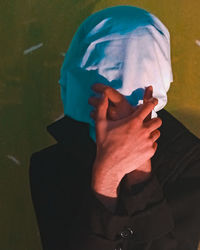 Low section of person holding a covered with face