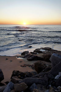 View of calm beach at sunset