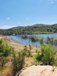 Scenic view of lake against blue sky