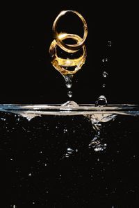 Close-up of water splashing against black background