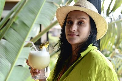 Portrait of young woman drinking mocktail