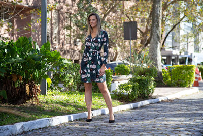 Portrait of woman standing against plants