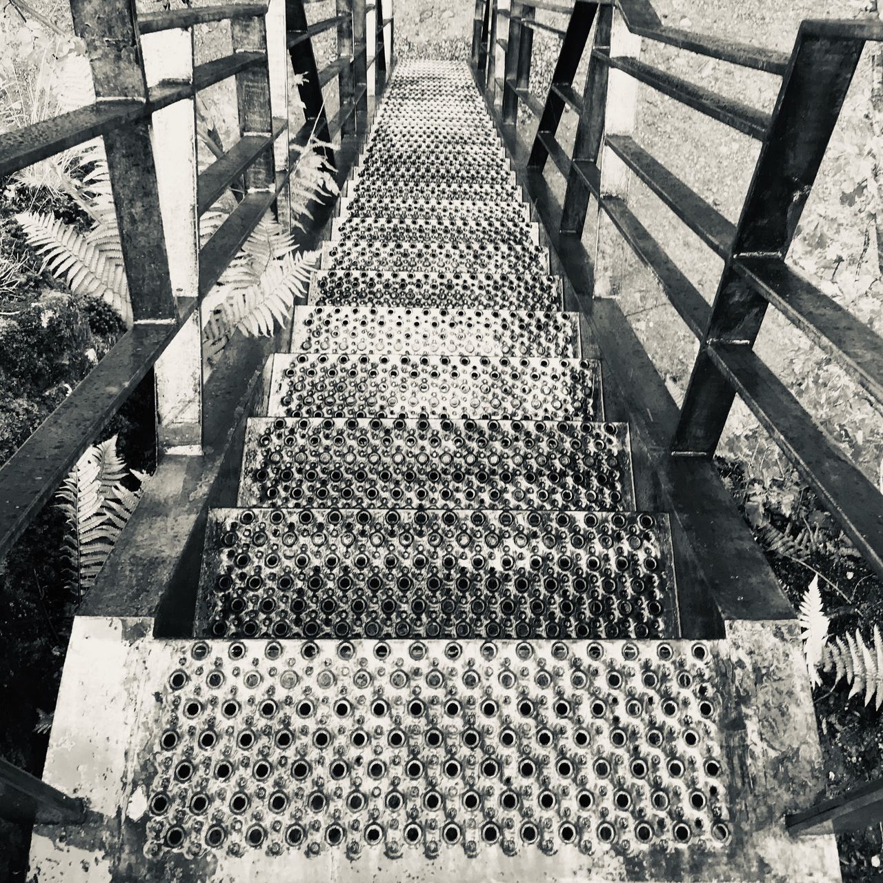 HIGH ANGLE VIEW OF STEPS AMIDST BRIDGE