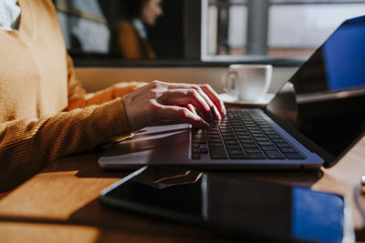 Freelancer using laptop in cafe
