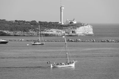 Sailboat sailing on sea against clear sky