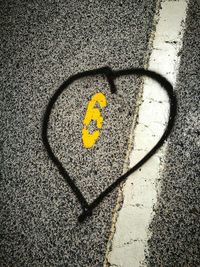 High angle view of yellow shadow on street