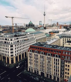 Fernsehturm amidst cityscape against sky