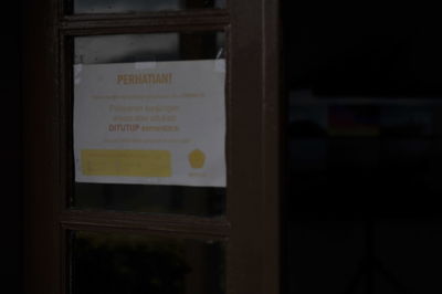 Close-up of text on glass window