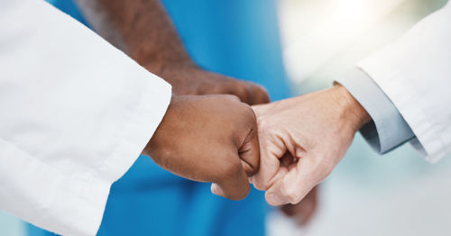 Midsection of wedding couple holding hands