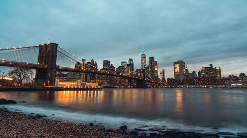 Bridge over river with buildings in background