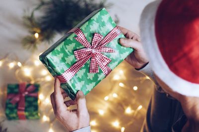 High angle view of man holding christmas present