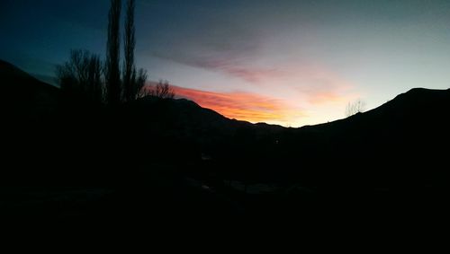 Scenic shot of silhouette mountains at sunset