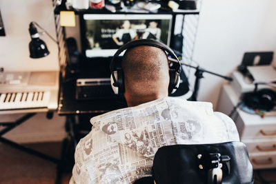 High angle view of disabled musician listening to music at recording studio