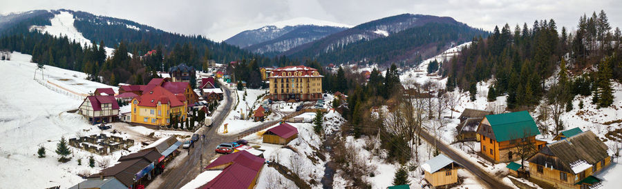 High angle view of trees and houses against sky during winter