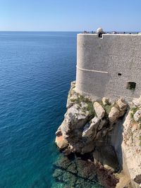 Rock formations by sea against sky