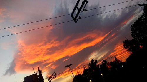 Low angle view of silhouette trees against sky during sunset