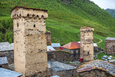 Old ruin building by tree mountain against sky