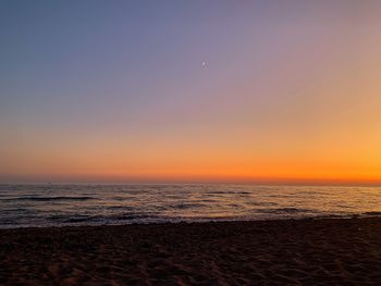 Scenic view of sea against clear sky during sunset
