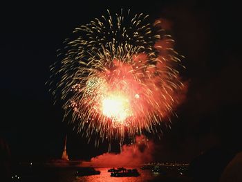 Low angle view of firework display at night