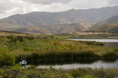 Scenic view of river and mountains