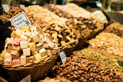 Various sweet food in wicker basket for sale at market stall