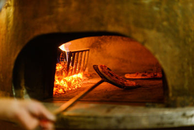 Cooking pizza in the wood copper oven