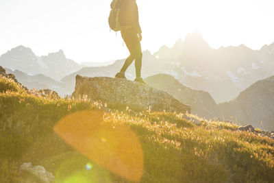 Lower half of backpacker hiking on mountain ridge