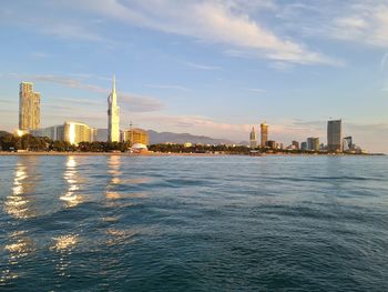 Sea with buildings in background